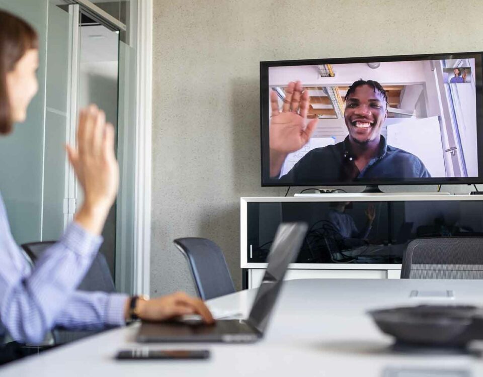 A woman is on a video call with a man discussing future trends in international trade.