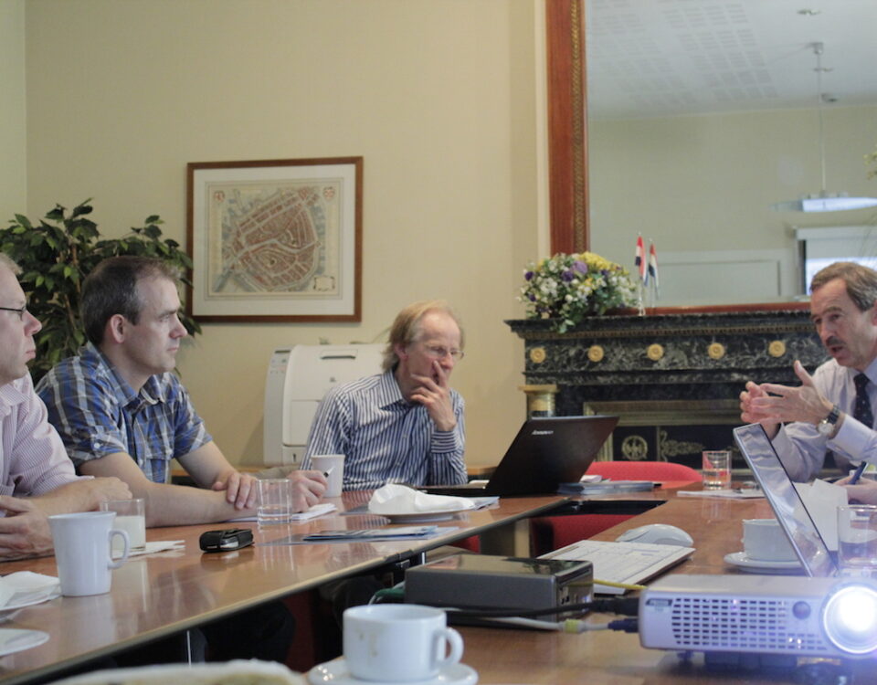 A group of people facilitating international trade and diplomacy while sitting around a table.