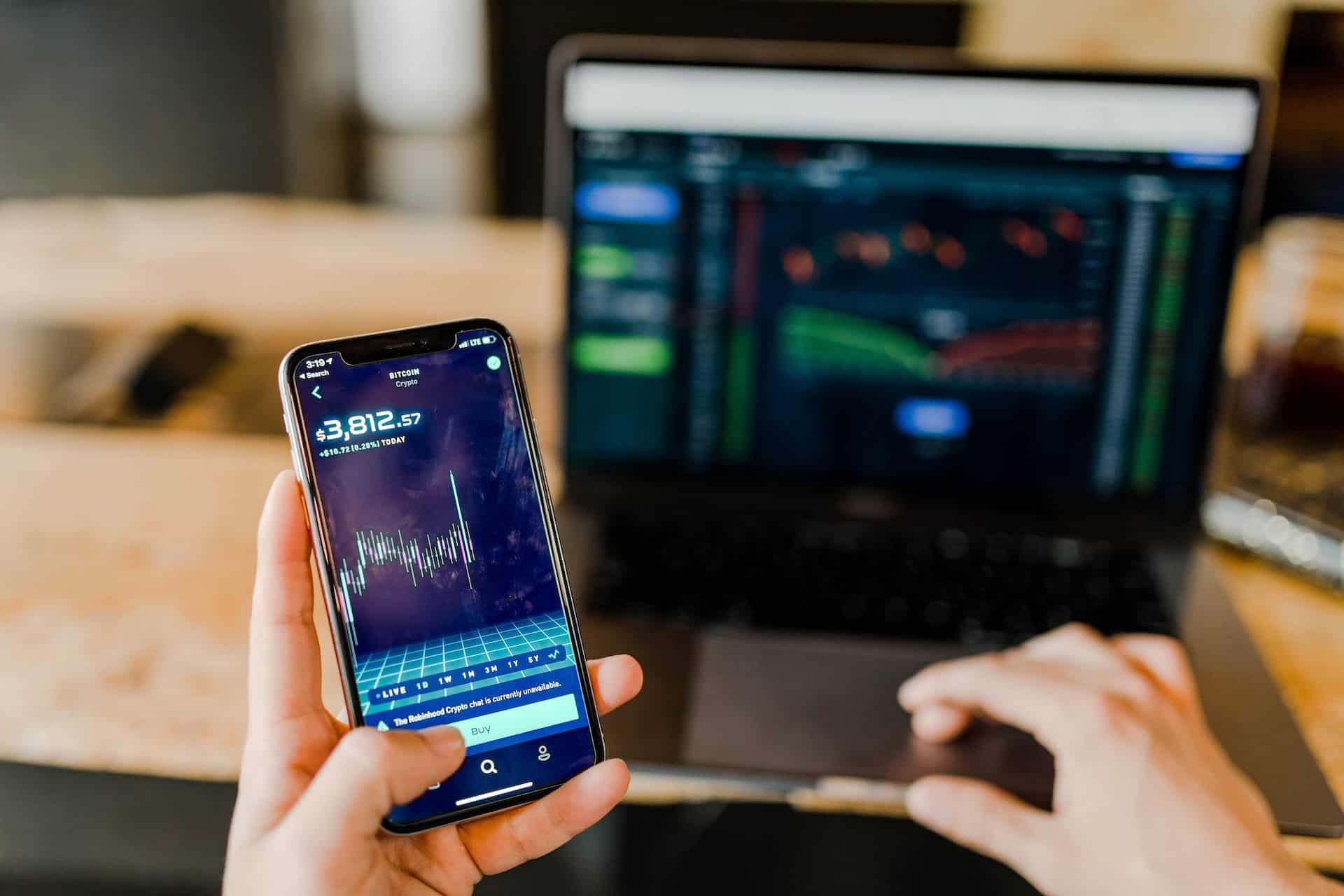 A person leveraging a trading app on their phone.