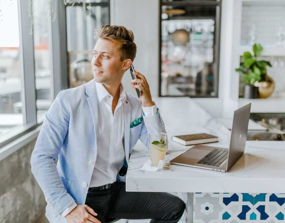 A man sitting at a bar and working on marketing materials adaptation.