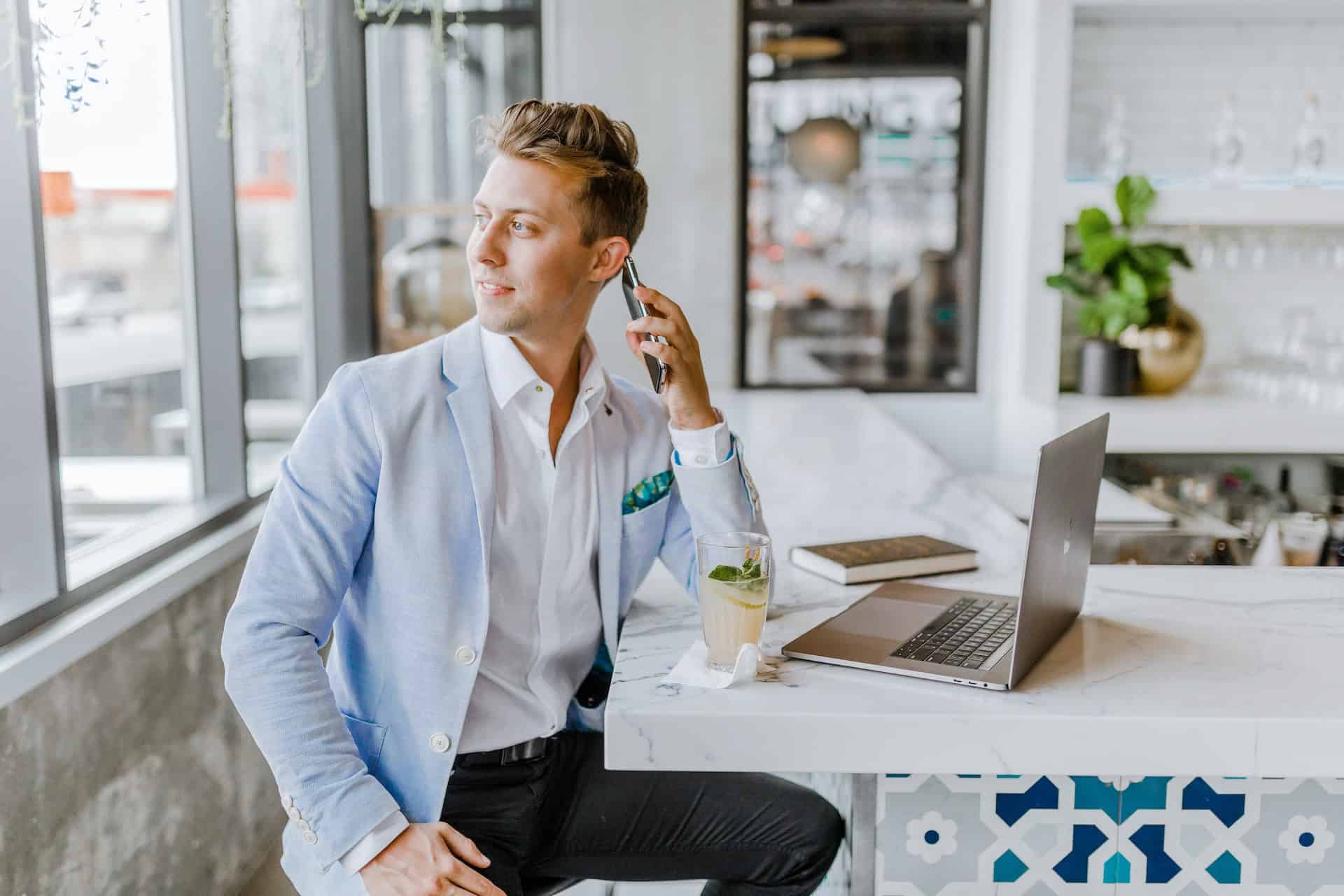 A man sitting at a bar and working on marketing materials adaptation.