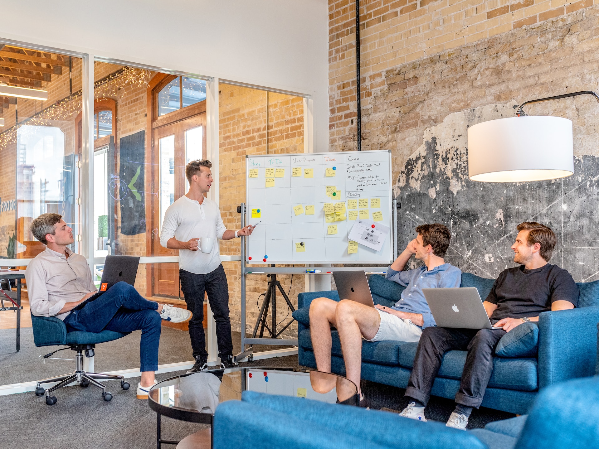 A group of people with a strong brand presence sitting around a table in an office, discussing strategies for entering foreign markets.