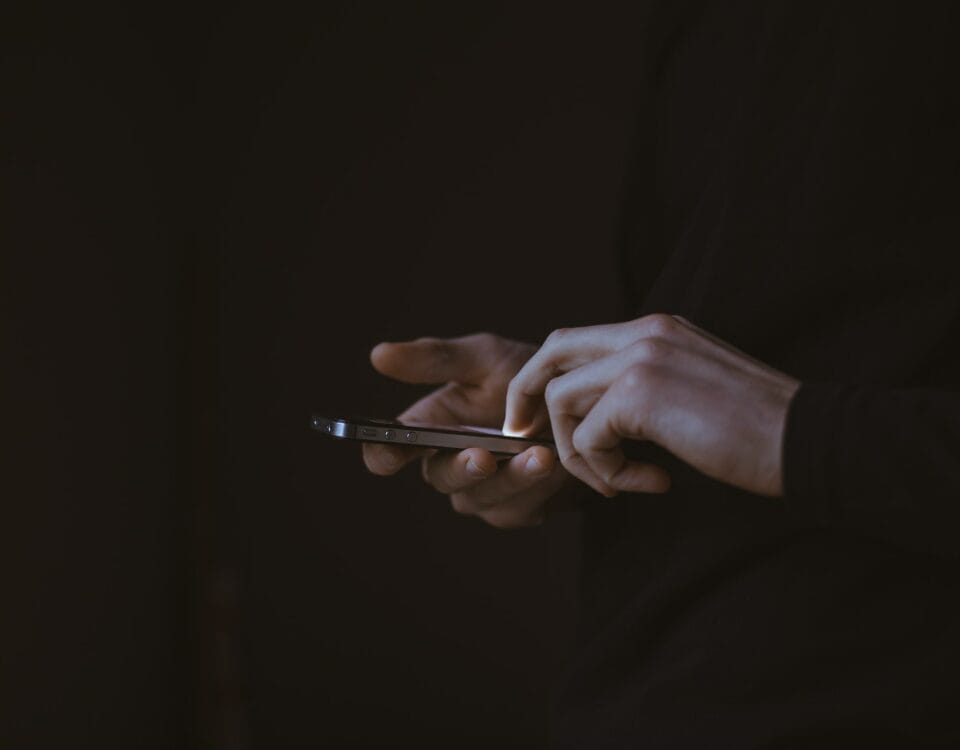 A person engaging in the digital economy while holding a cell phone.