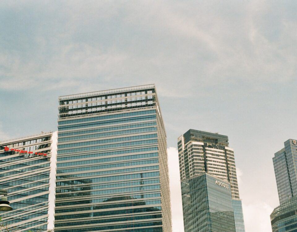 A group of tall buildings in a city, championing globalization and international trade.