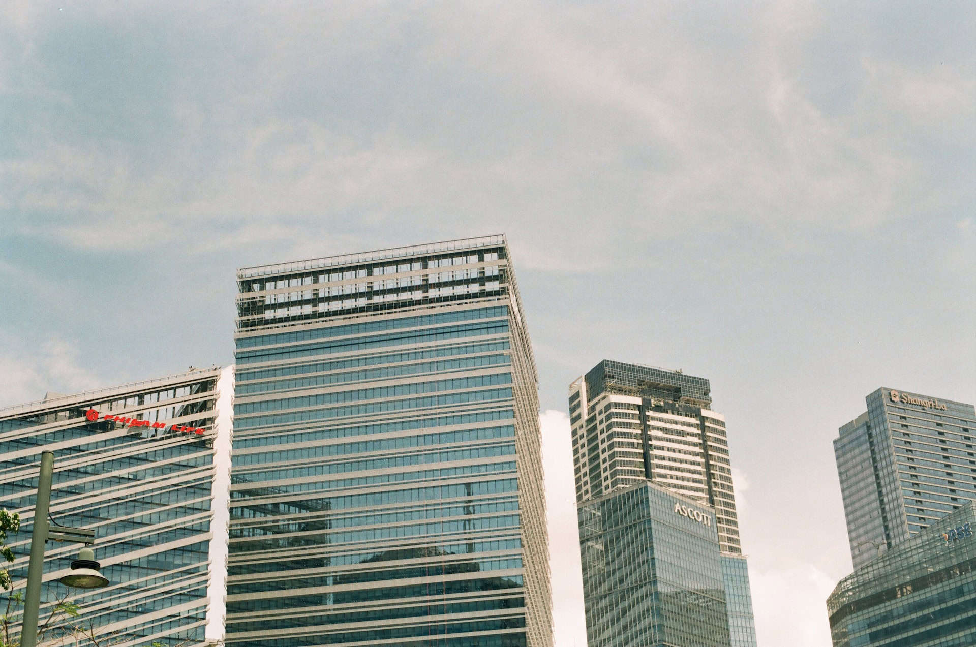 A group of tall buildings in a city, championing globalization and international trade.