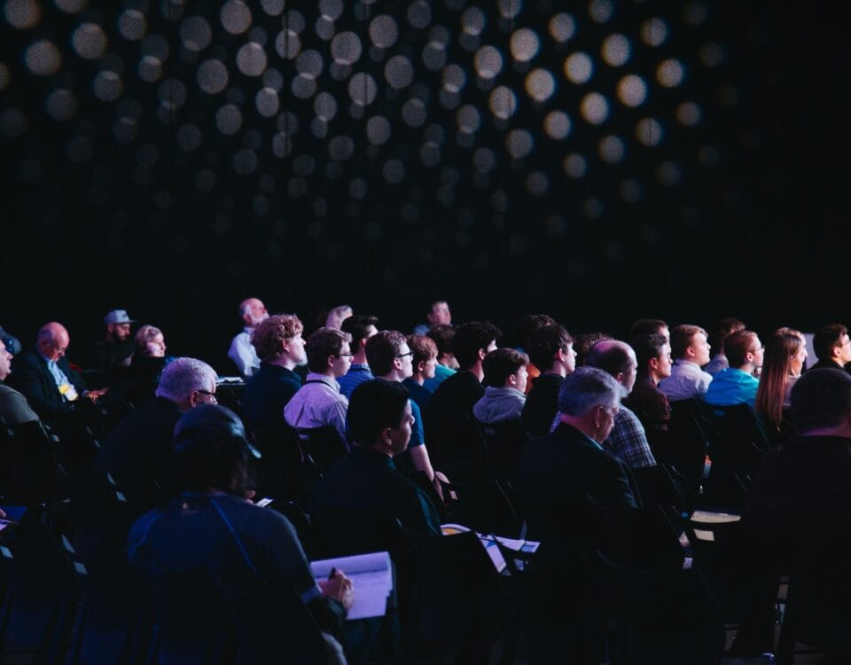 A group of people sitting in chairs at a conference discussing climate action.