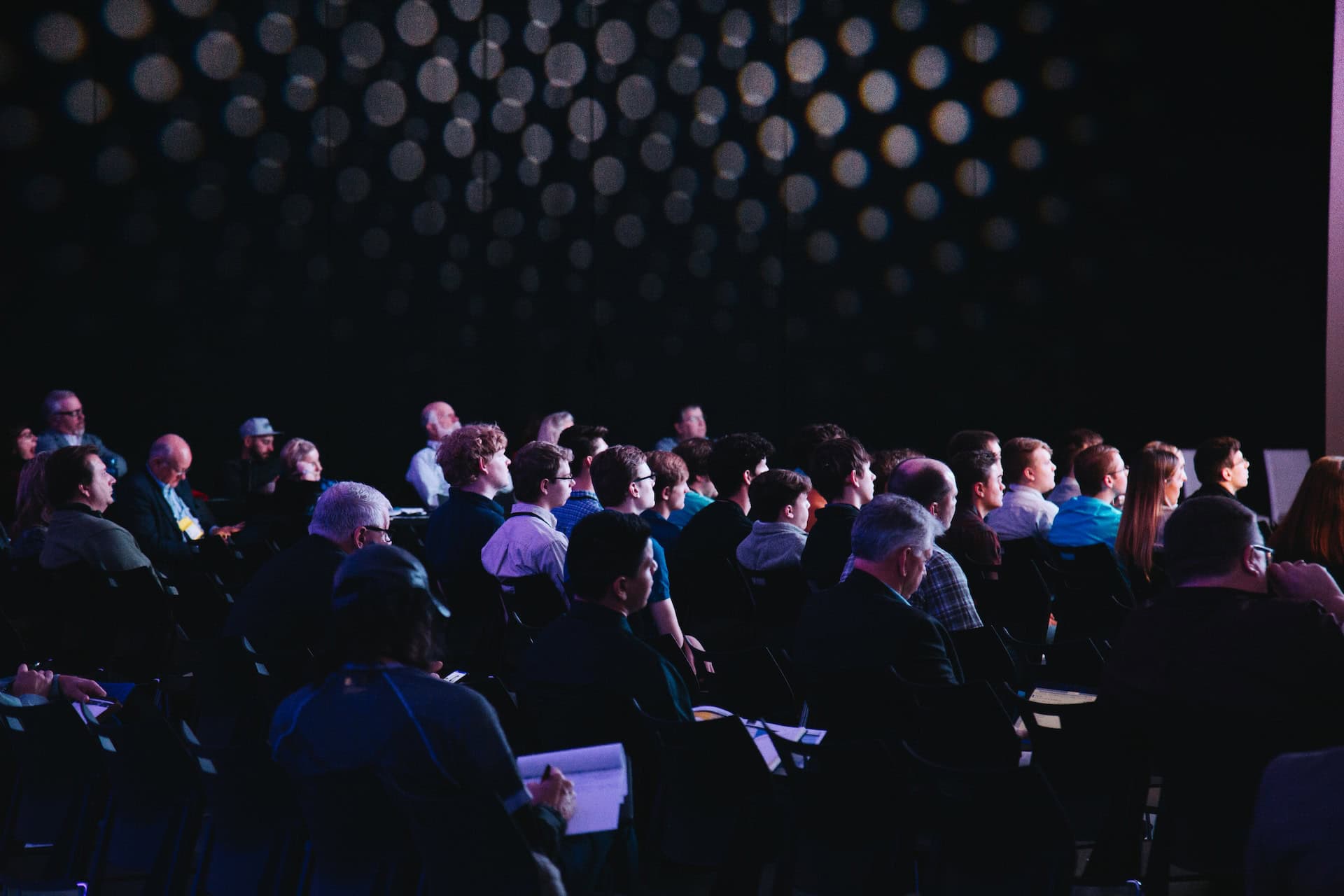 A group of people sitting in chairs at a conference discussing climate action.