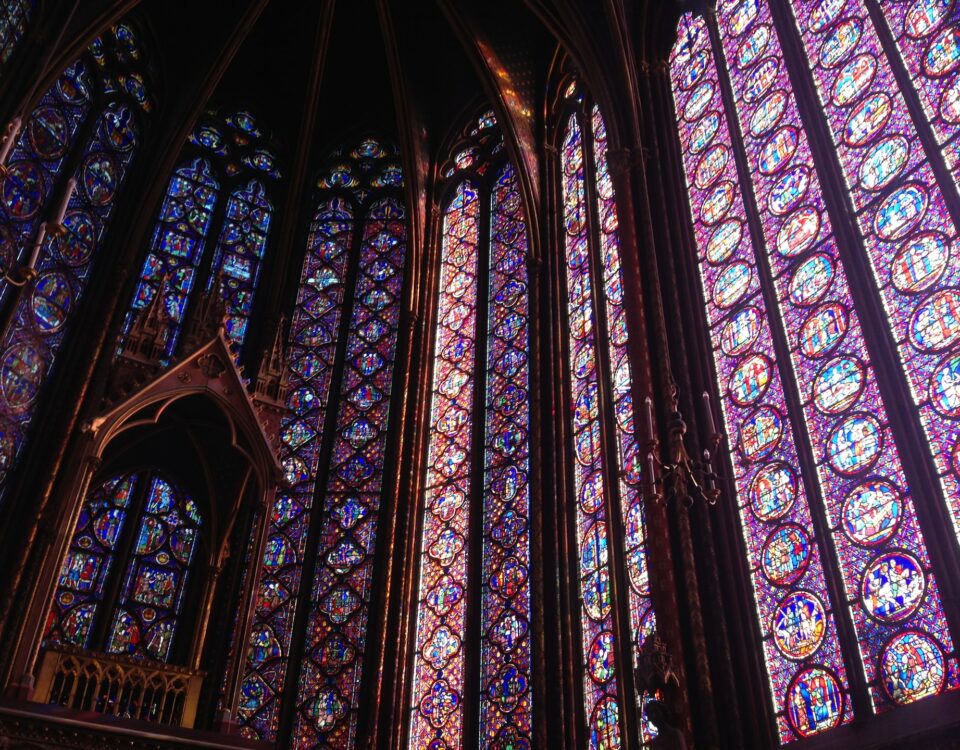 Stained glass windows depicting women in a church.