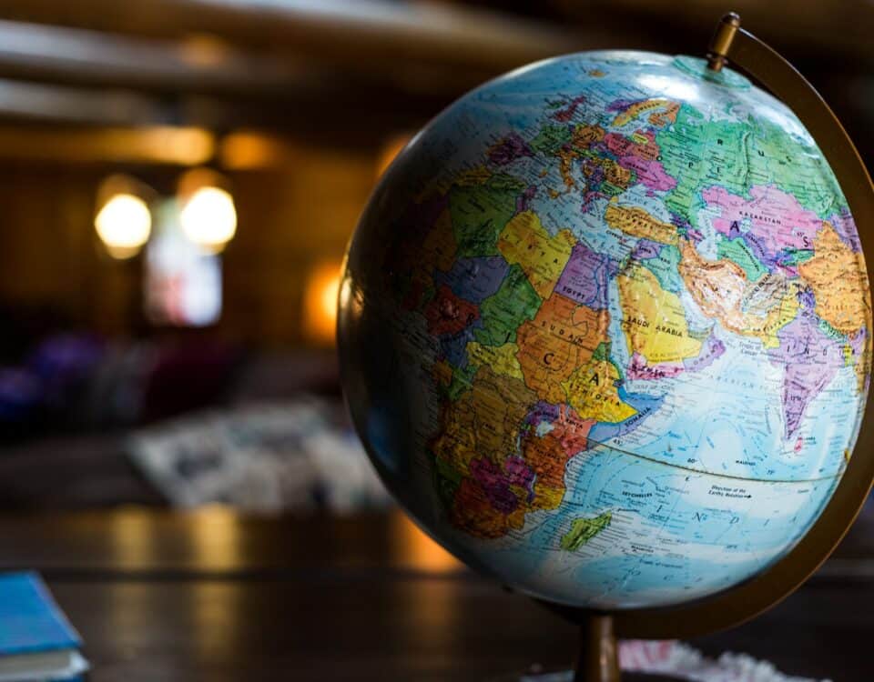 A globe sits on a table in a room, symbolizing the importance of understanding in promoting free trade.