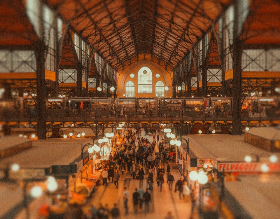 A bustling market teeming with people from diverse backgrounds.