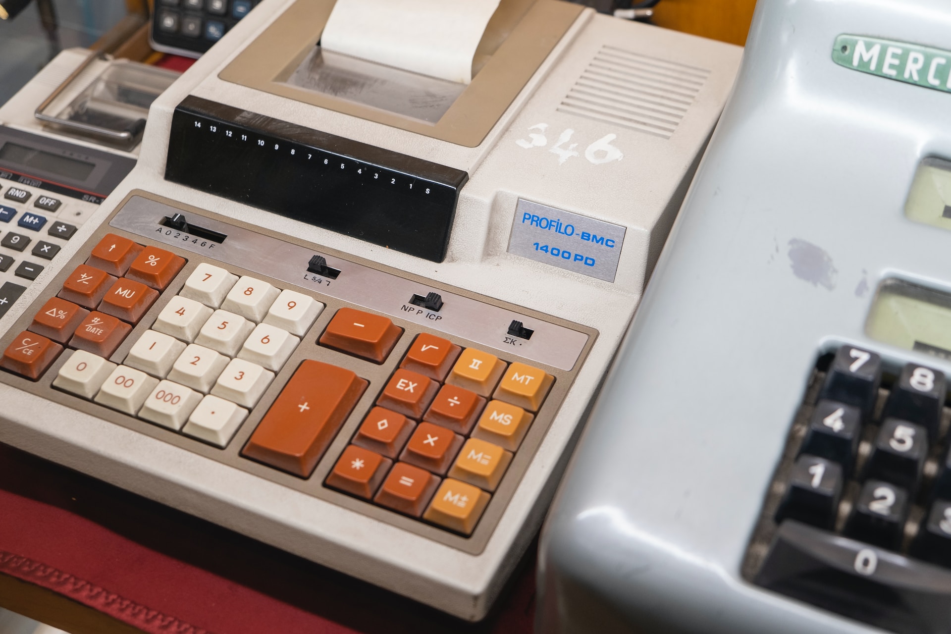 A cash register with a global pricing strategy, placed on a table.