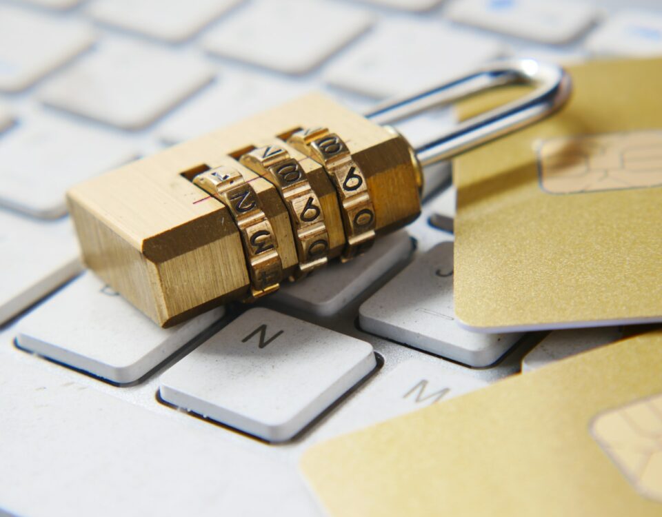 A gold padlock on a keyboard with credit cards, symbolizing secure intellectual property protection for international markets.