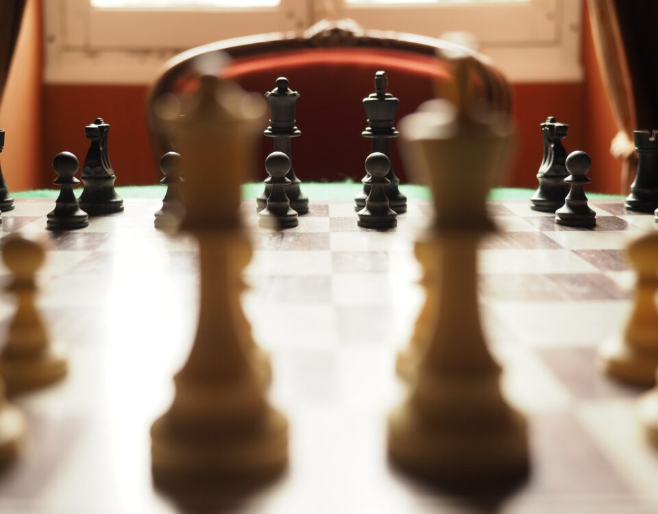 Chess pieces forming strategic partnerships on a chess board.