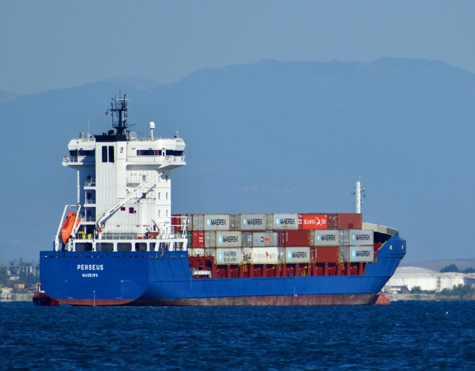 A blue and white container ship complying with international trade regulations.