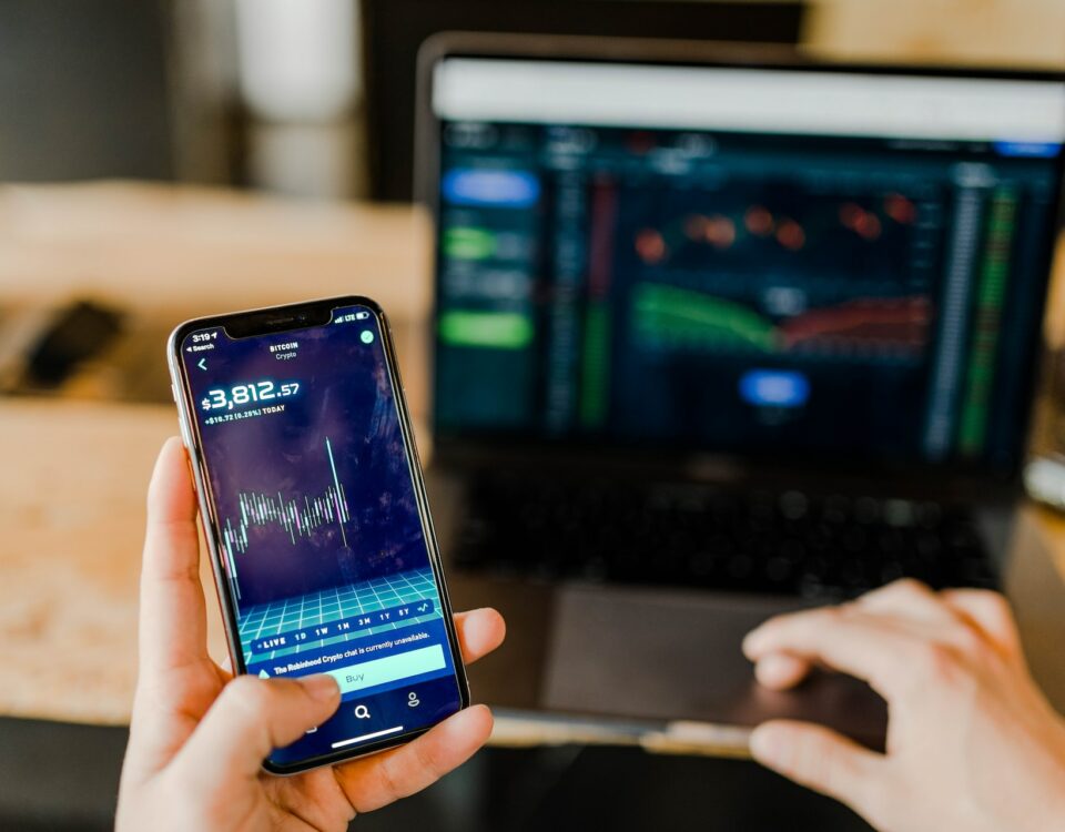 A person leveraging a trading app on their phone.