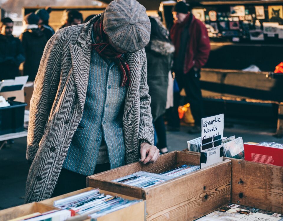 A man exploring records at a flea market, considering diversification strategies for the export market.