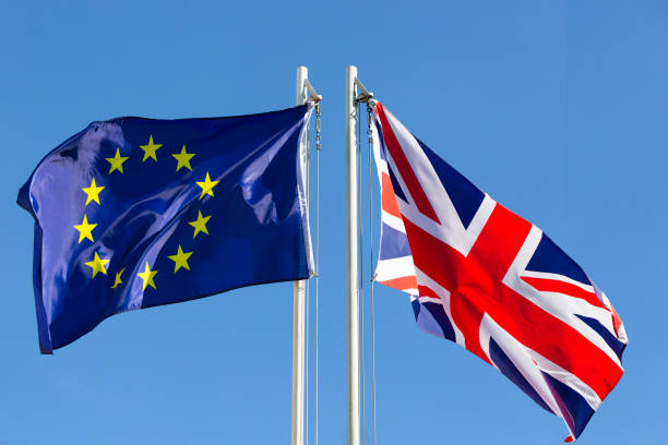 Two European flags flying in the sky, symbolizing International Trade amidst Brexit.