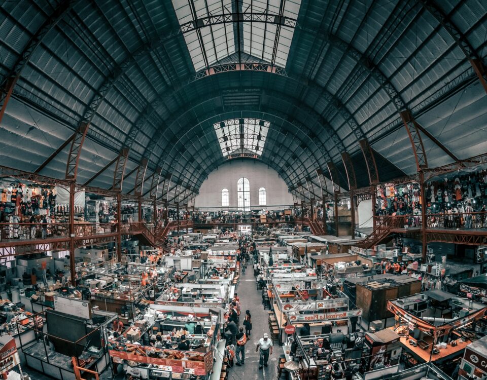 A view of a bustling indoor market with an abundance of people.