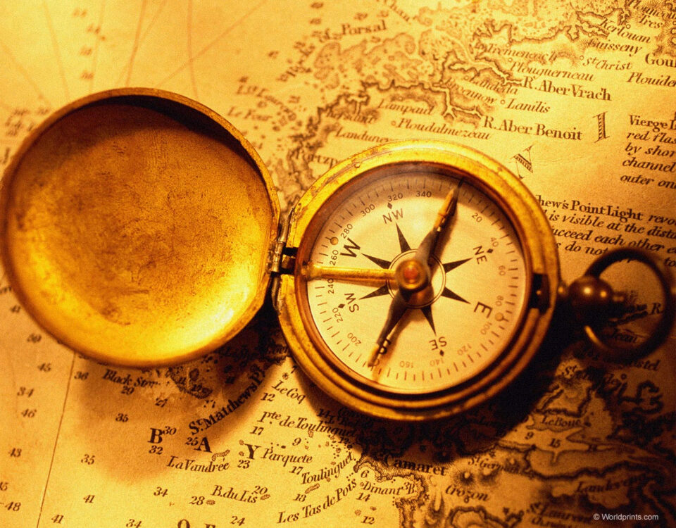 A gold compass atop a map guiding through international trade laws.