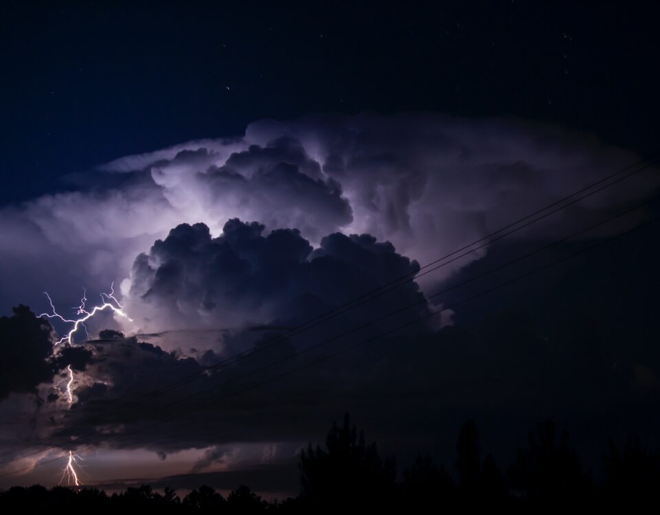A climate change-induced lightning bolt is seen in the night sky.
