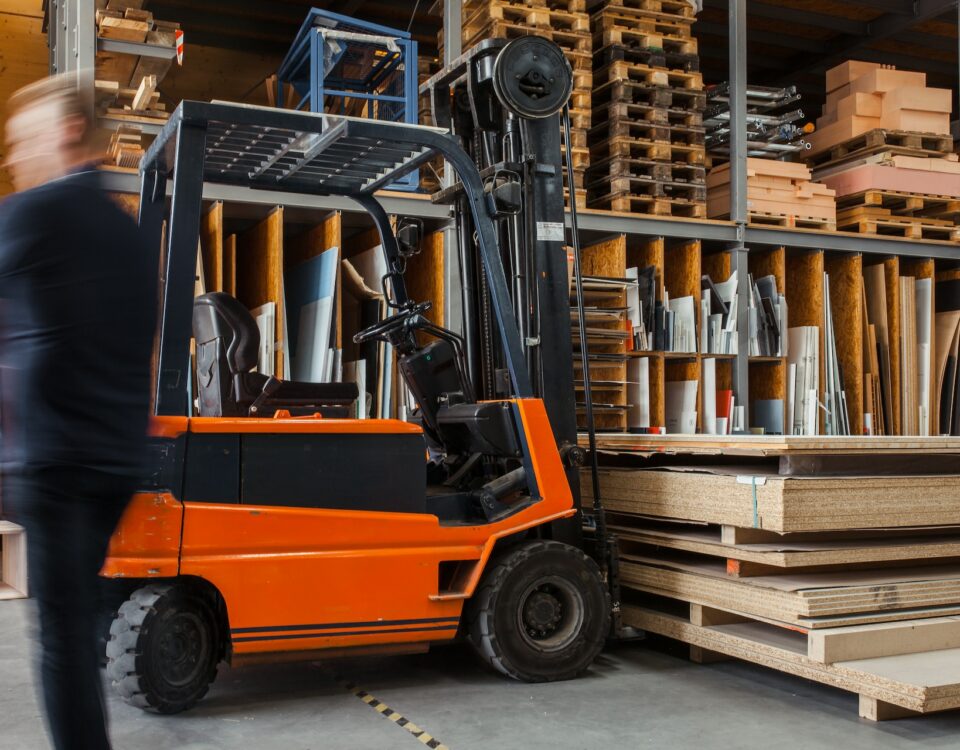 An international forklift truck efficiently moves and transports product packaging in a warehouse.