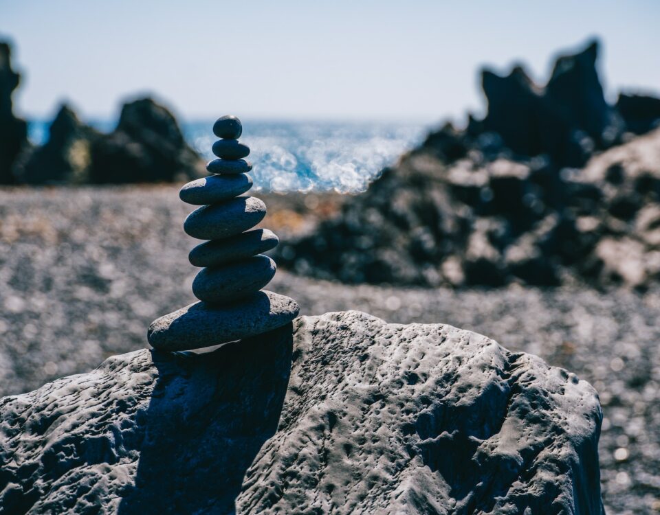 A sustainable stack of rocks on top of a beach.