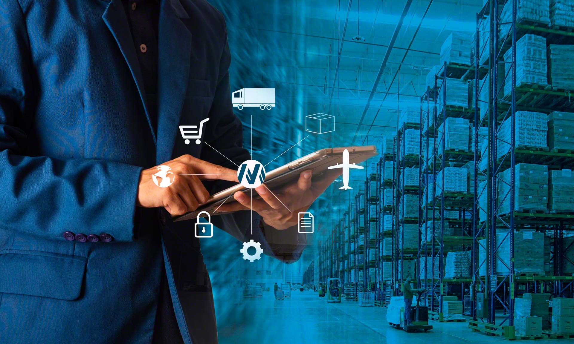 A man in a suit is using a tablet to manage supply chain operations in a warehouse.