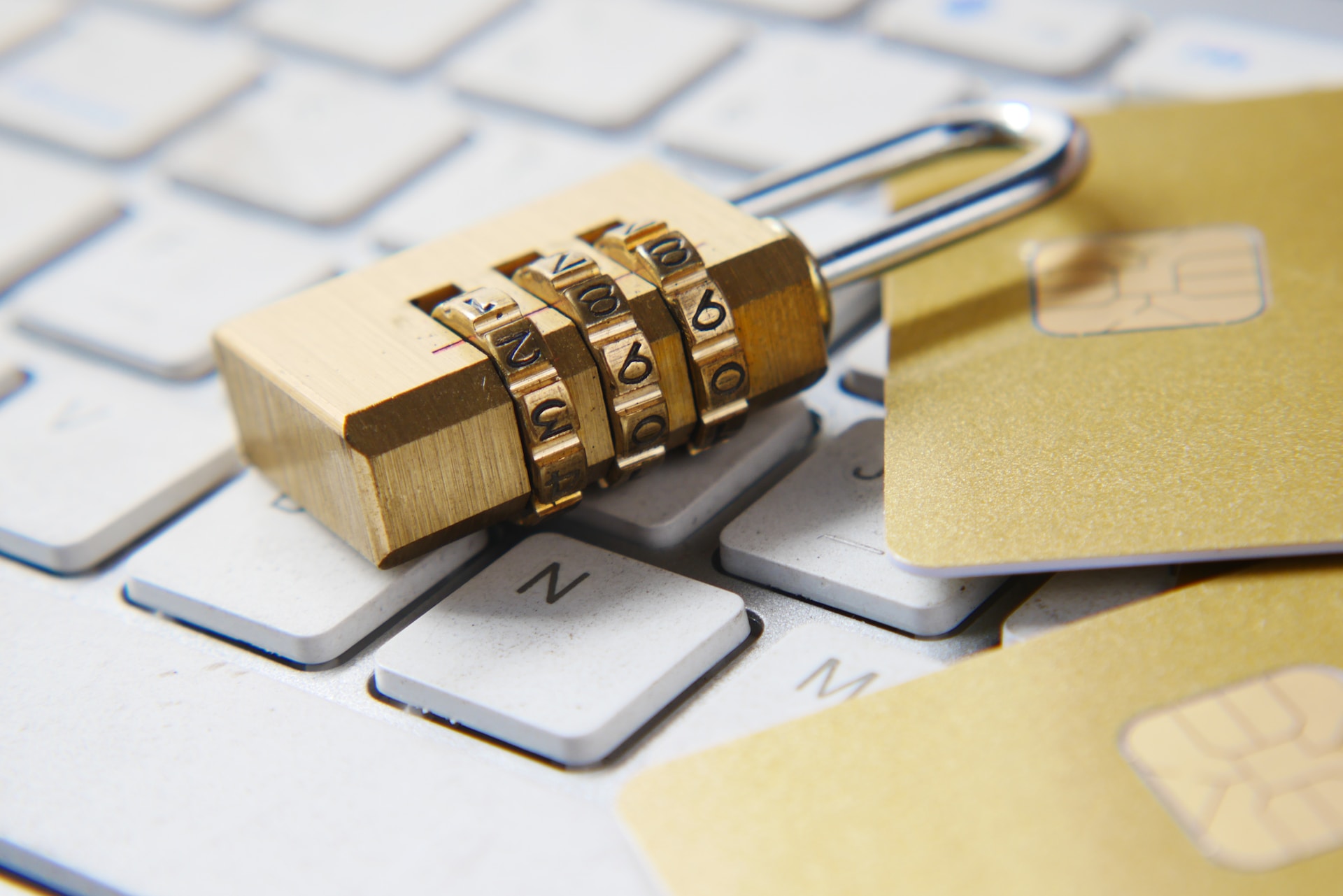 A gold padlock on a keyboard with credit cards, symbolizing secure intellectual property protection for international markets.