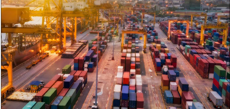 An aerial view of a container port facilitating global trade at sunset.